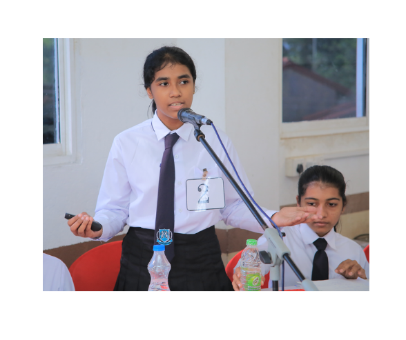 A student delivering a speech at a microphone